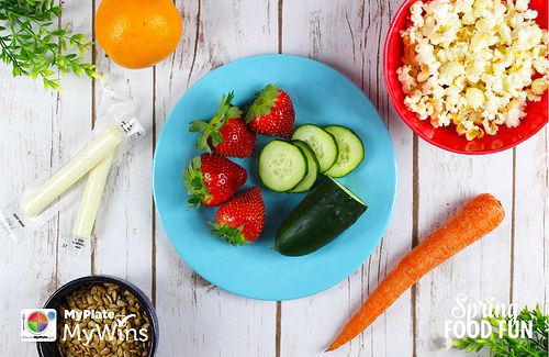 Plate with vegetables and other foods placed around on a table