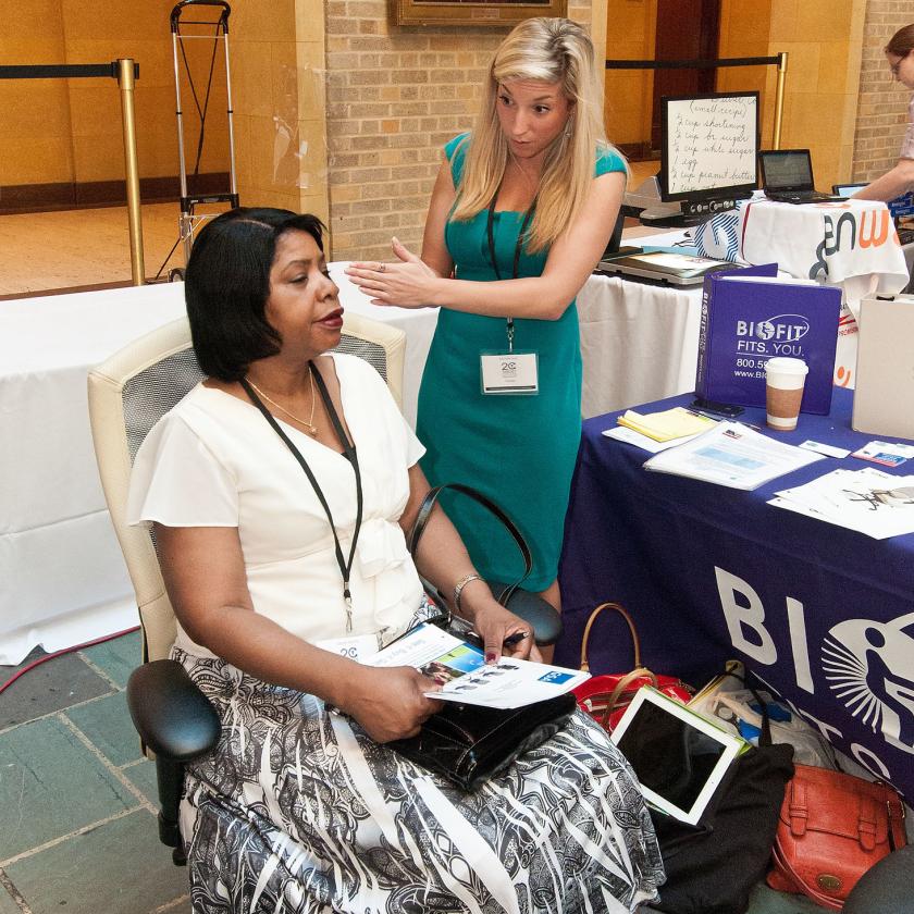 Demonstration of an ergonomic chair to at the Target Center 20th Anniversary at USDA.