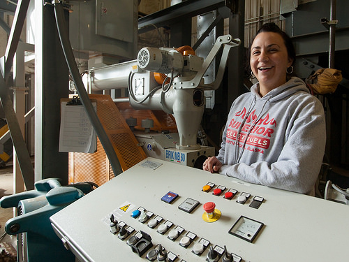 A woman in a wood pellet production facility